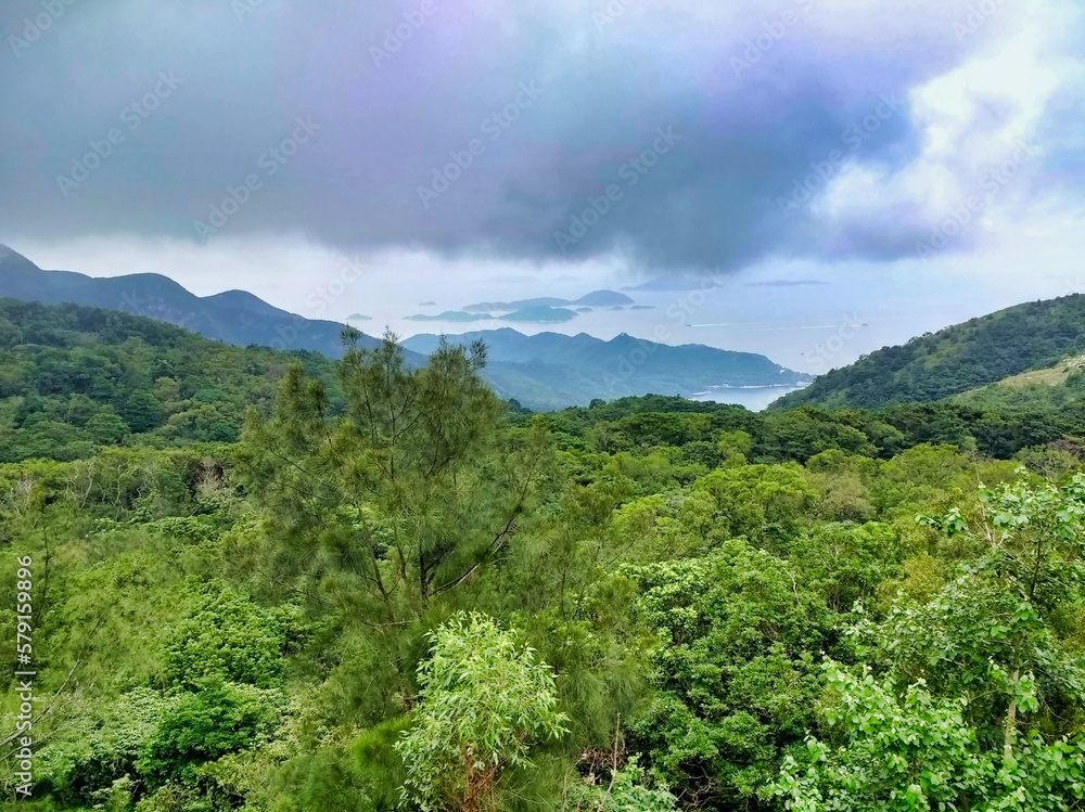 Lantau Island. Mountain Hills and Green trees on the slopes. Sea and islands in the background. Hong Kong. China. Asia