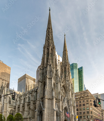 New York, USA - April 23, 2022: View of the St. Patricks Cathedral in Midtown Manhattan with the famous 5th Avenue. Its a decorated Neo-Gothic-style Roman Catholic cathedral church photo
