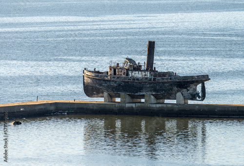 Billede på lærred Abandoned wooden steam ship on stands on pier in Montevideo harbor in Uruguay