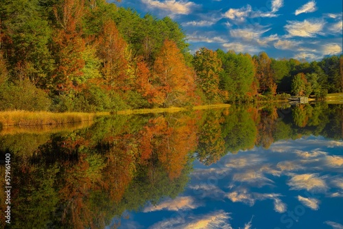 Shorts Lake is surrounded by hardwood trees showing fall color, in Crowders Mountain State park, North Carolina