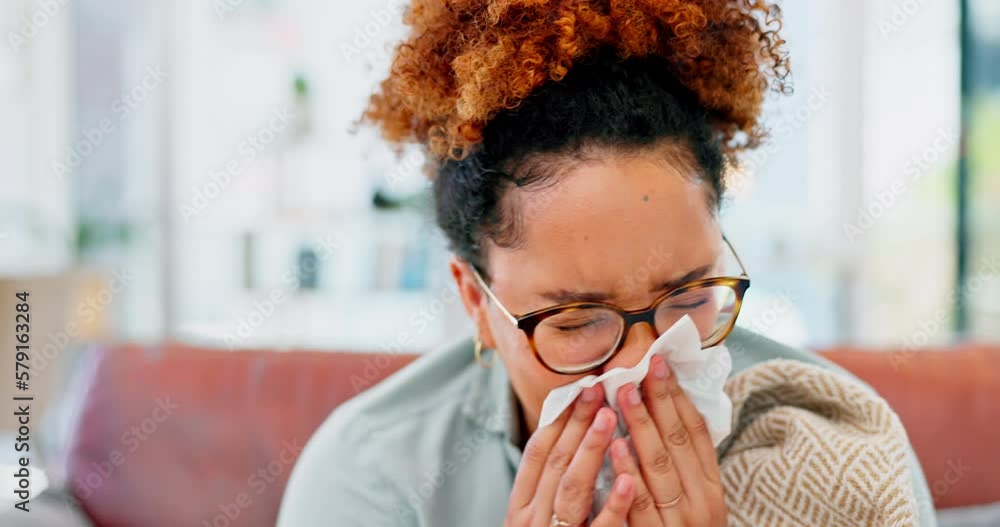 Sick, sofa and woman sneezing in a tissue while relaxing in the living