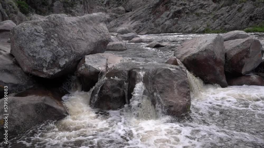 The rapids. Closeup view of the river flowing across the rocky canyon. The rapids. Closeup view of the river flowing across the rocky canyon.