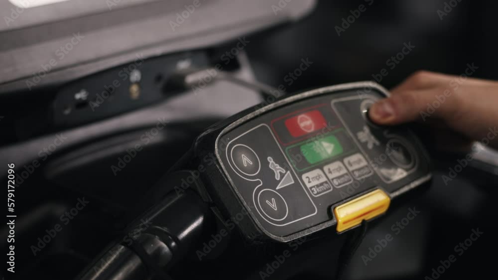 Gym workout, Treadmill control, Control panel. Control panel of treadmill is activated as man's hand pushes button. Gym workout, Treadmill control, Control panel. Control panel of treadmill is activated as man's hand pushes button.