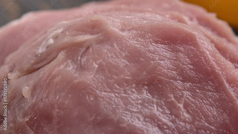 A large fork puts aside pieces of pork steaks A large fork puts aside pieces of pork steaks