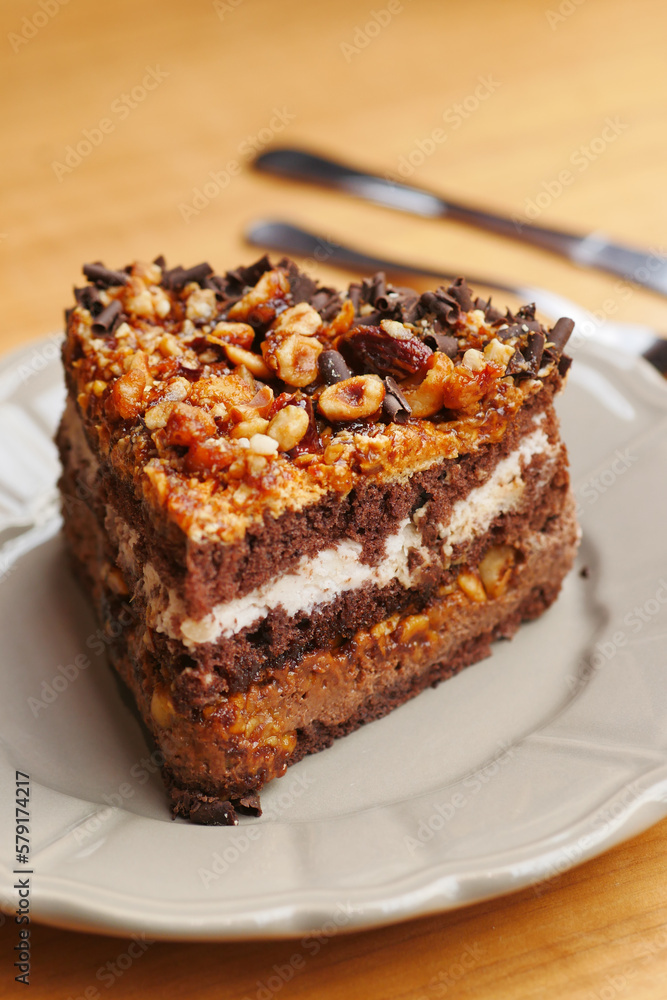 chocolate and cream cake on a plate on table chocolate and cream cake on a plate on table