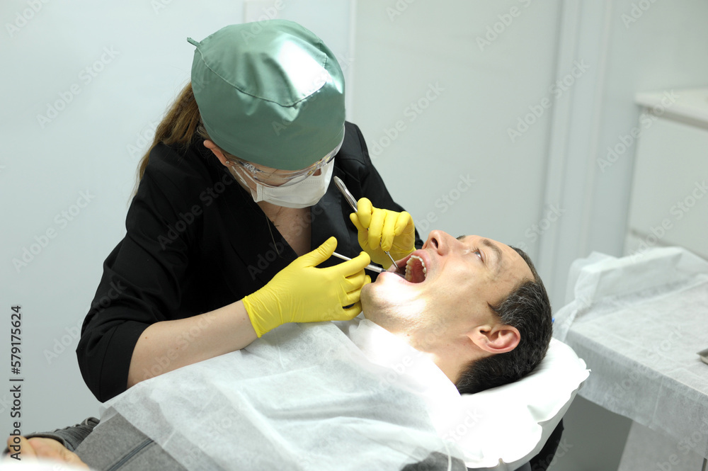 dental anesthesia in dentist's chair, needle of syringe, infiltration