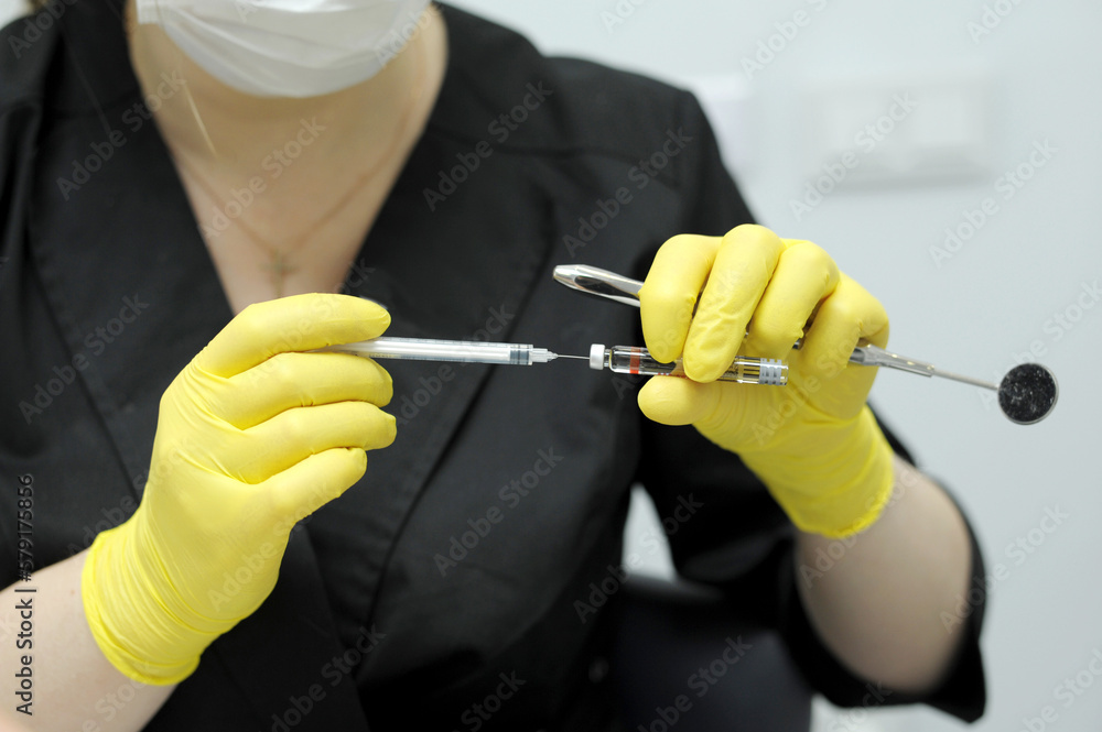 dental anesthesia in dentist's chair, needle of syringe, infiltration