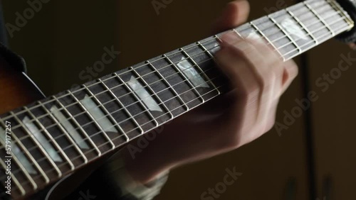 Slow ambient electric guitar solo, fretboard closeup, musician recording