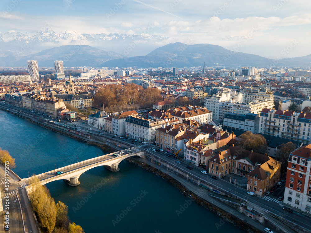 Panoramic aerial view of Grenoble city with bridge over Isere river, France