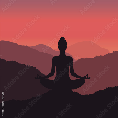 Fototapeta Naklejka Na Ścianę i Meble -  Silhouette of a woman meditating in the mountains at beautiful sunrise
