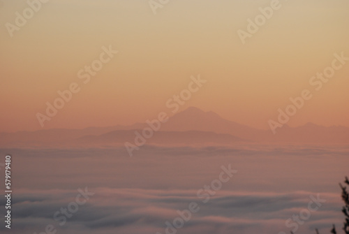 Hazy sunrise over a foggy mountain