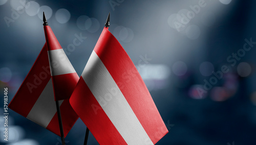 Small flags of the Austria on an abstract blurry background