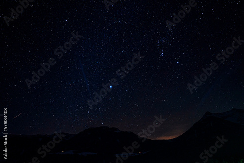 Scenic view of beautiful sky with stars glowing over silhouette mountain and landscape at night