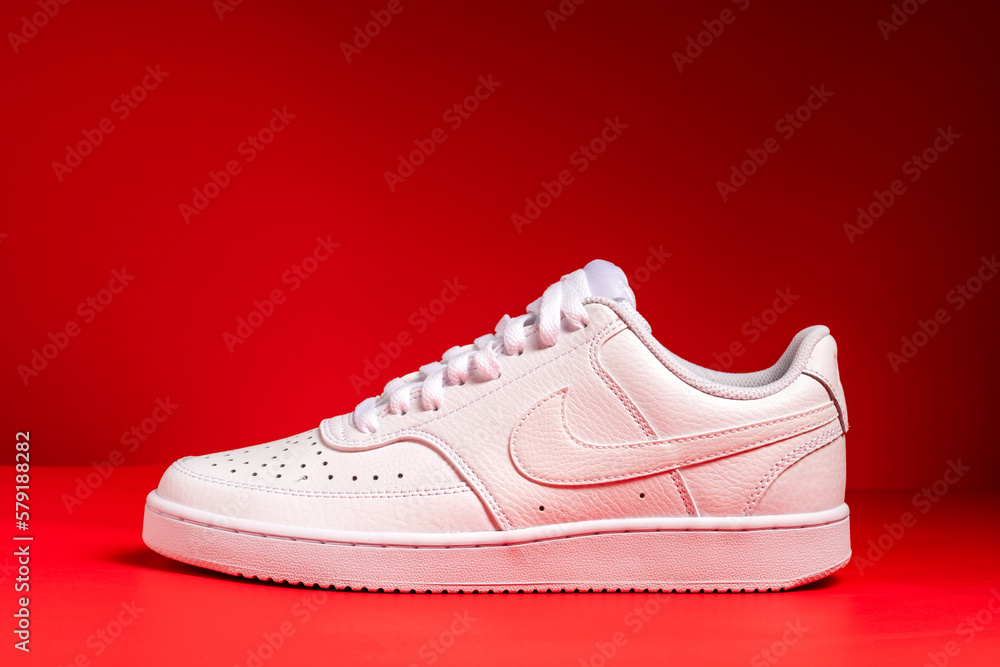 Nike white sneakers product shot isolated on red background