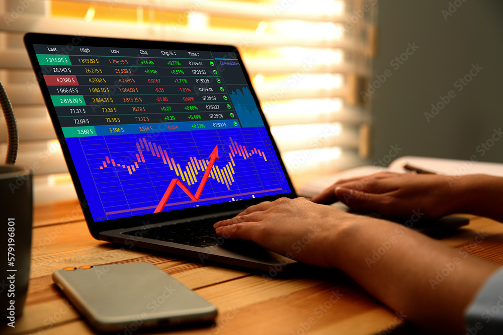 Woman analyzing situation on stock exchange market via laptop, closeup. Data and graph on screen Woman analyzing situation on stock exchange market via laptop, closeup. Data and graph on screen