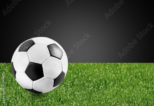 Official Football Ball on green grass at stadium
