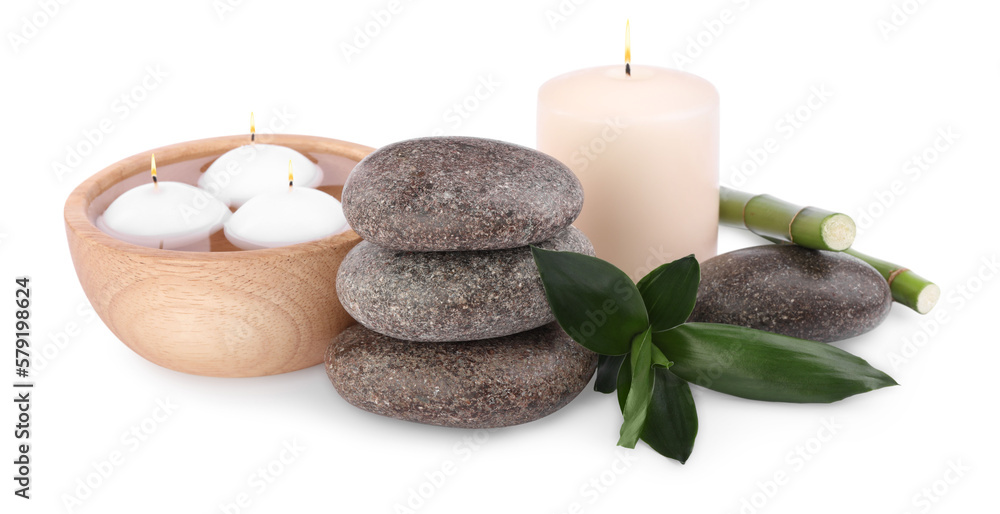 Spa stones, candles and bamboo on white background Spa stones, candles and bamboo on white background