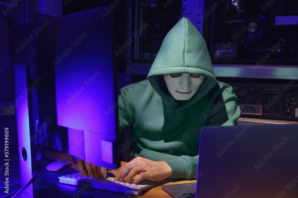 Hacker working with computers in dark room. Cyber attack