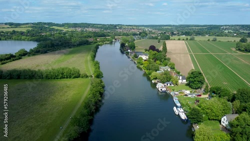 Smooth 4k drone footage flying over the river Thames from Marlow towards Bourne End Buckinghamshire UK