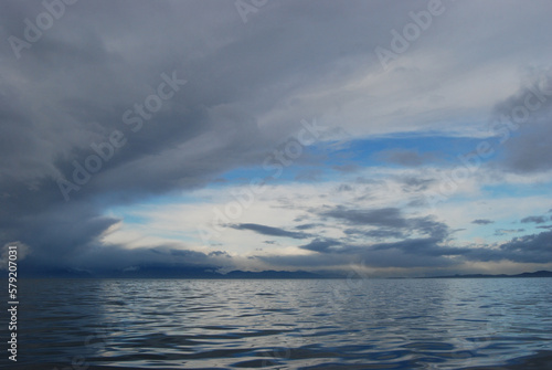 Reflections of storm clouds on a wavy but calm Juan De Fuca Strait near Victoria  BC