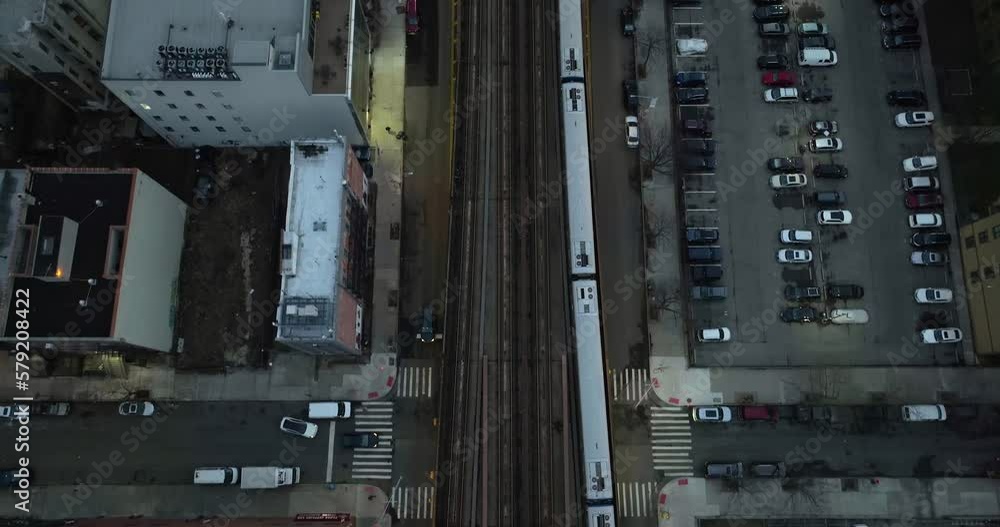 Aerial view above a train driving on elevated rails in illuminated New York, USA - top down, drone shot Aerial view above a train driving on elevated rails in illuminated New York, USA - top down, drone shot