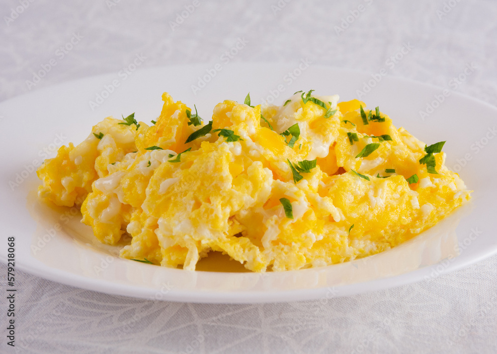 Scrambled Eggs with Seasonings on White Plate for Breakfast Scrambled Eggs with Seasonings on White Plate for Breakfast