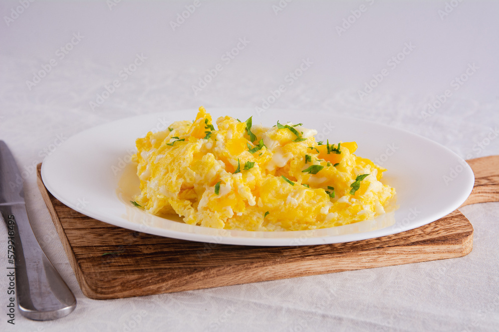 Scrambled Eggs with Seasonings on White Plate for Breakfast or Lunch Scrambled Eggs with Seasonings on White Plate for Breakfast or Lunch