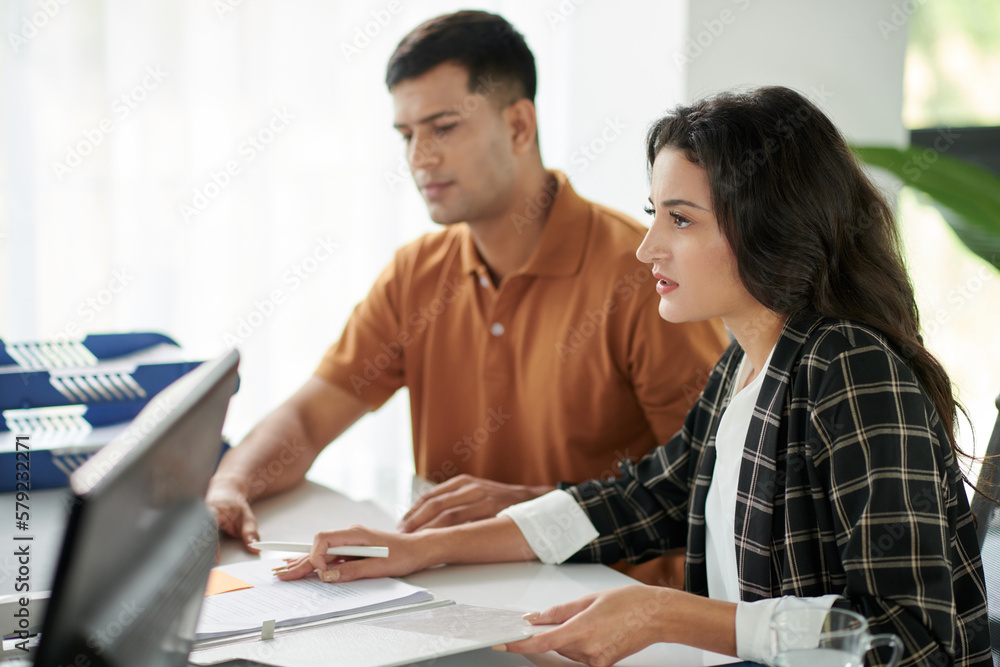 Couple asking questions when signing documents at meetign with manager Couple asking questions when signing documents at meetign with manager