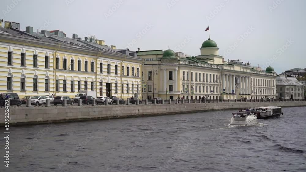 Touristic passenger sailing ships, yachts and boats. The city buildings on Fontanka river. Town embankment and bridge. Touristic passenger sailing ships, yachts and boats. The city buildings on Fontanka river. Town embankment and bridge.