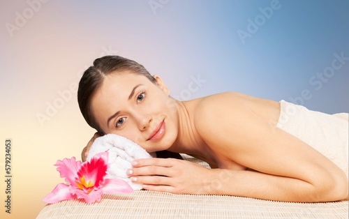 Happy young woman after facial treatment.