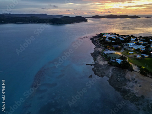 Aerial orange sunset showing the beach and town of Torres Strait