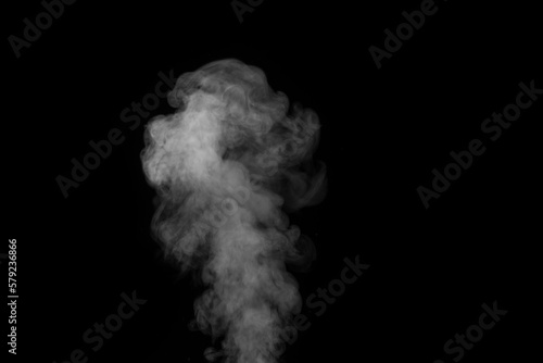 Curly white steam rising up and splashing water scattering in different directions isolated on a black background.