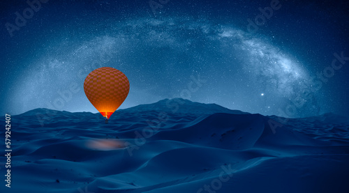 Hot air balloon flying over Sahara desert - Amazing milky way over the sand dunes of Sahara Desert with hot air balloon - Sahara, Morocco