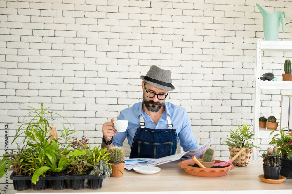 An elderly man handsome with have mustache wearing glasses is happy with tree care. is a hobby of gardening at home, living happily after retirement. Concepts nature and environment An elderly man handsome with have mustache wearing glasses is happy with tree care. is a hobby of gardening at home, living happily after retirement. Concepts nature and environment