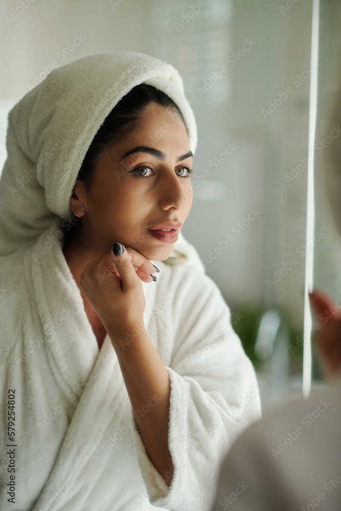 Young woman touching her smooth skin after taking morning shower Young woman touching her smooth skin after taking morning shower