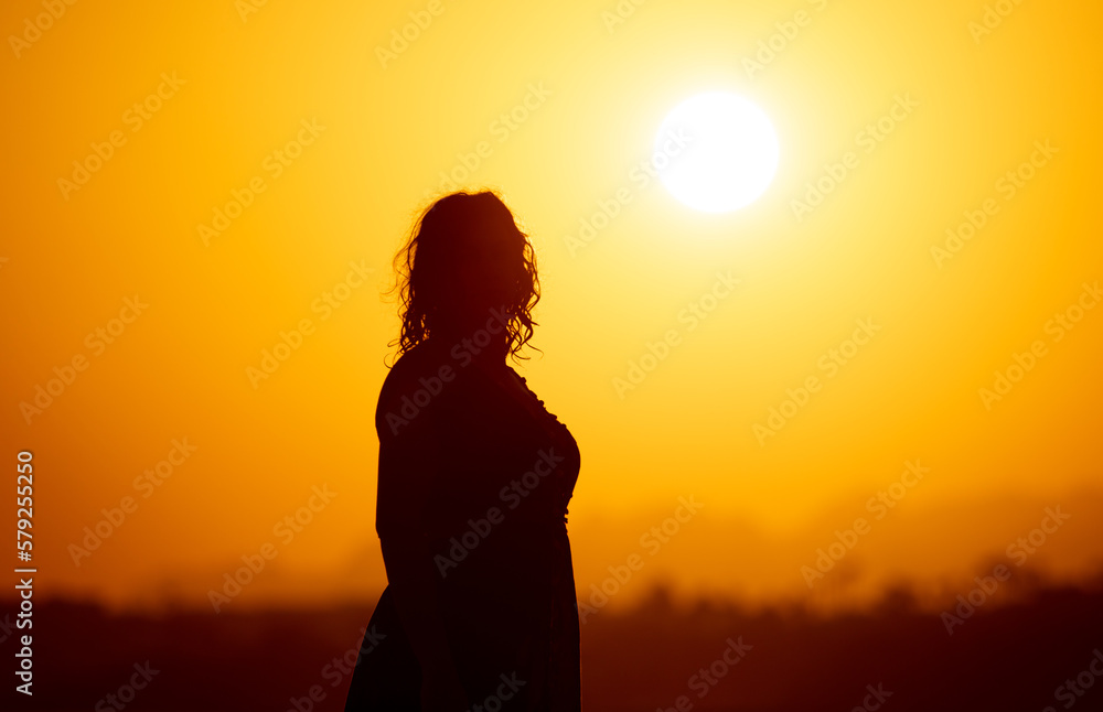Silhouette of a girl on the seashore.