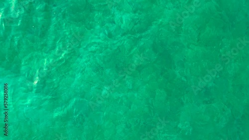 Beautiful low to mid altitude drone view of Lake Attersee, Upper Austria, Europe, on a dark, cloudy, cold early spring day - camera looks down, then pans up to horizon flying forward