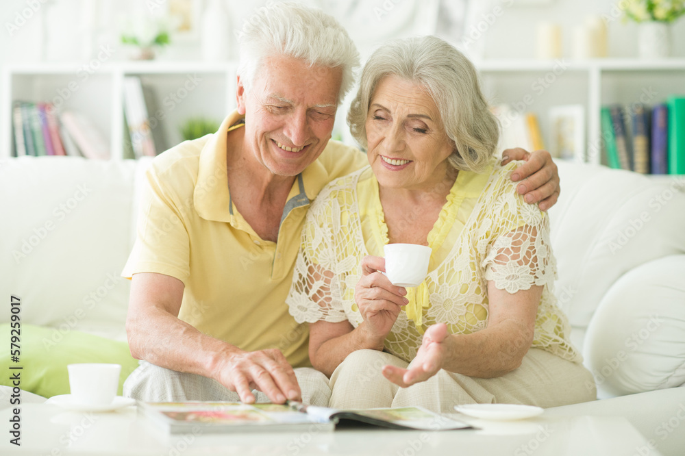 mature couple with magazine drinking tea mature couple with magazine drinking tea