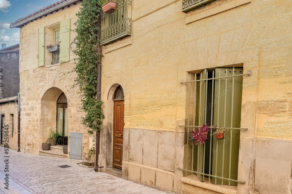 Uzes in France, old facades in the historic center, typical street
