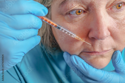 senior woman gets injection in her lips. Woman in beauty salon. plastic surgery clinic.