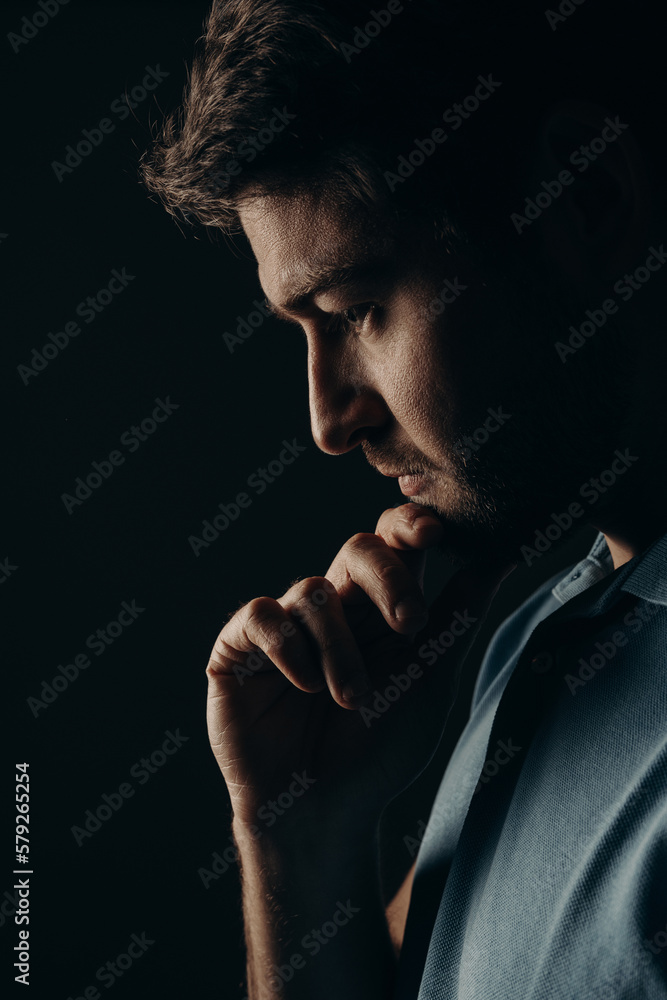 The young guy thought. Portrait on a dark background.