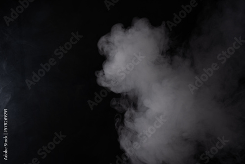 Cloud of white smoke on a black background closeup