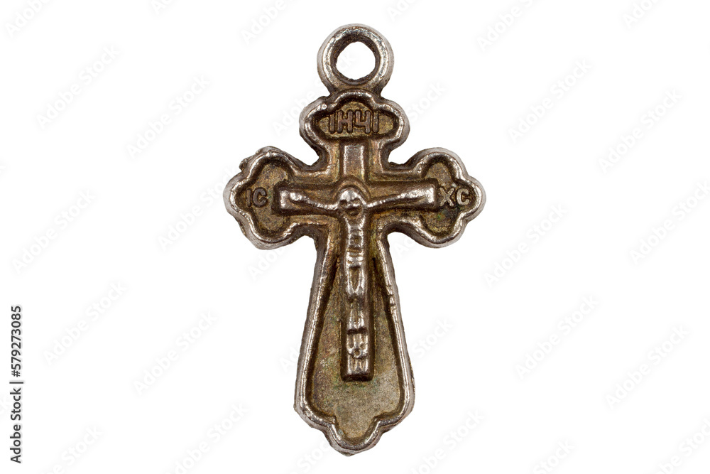 Antique metal cross on a white background. Cross close-up. Religious symbol.