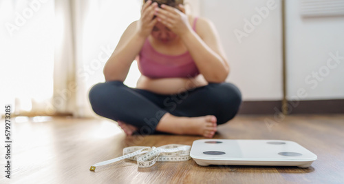 Fotografie Obese Woman with fat upset bored of dieting Weight loss fail  Fat diet and scale