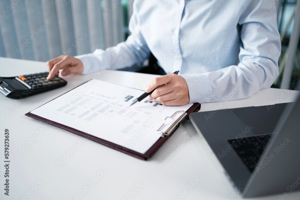 Fototapeta premium Asian Woman working by using a laptop computer Hands typing on keyboard. Working at office professional investor working new start up