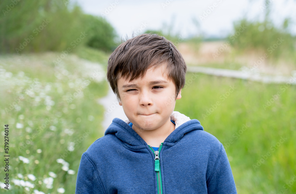 Portrait Smiling Kid enjoy playing outside in the morning,Happy young boy playing outdoor in the garden,Child relaxing on sunny day Spring or Summer in the park, Learn and Play Outdoors Activity Portrait Smiling Kid enjoy playing outside in the morning,Happy young boy playing outdoor in the garden,Child relaxing on sunny day Spring or Summer in the park, Learn and Play Outdoors Activity