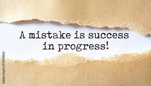 'A mistake is success in progress' written under torn paper.