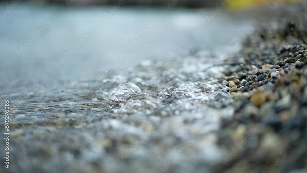 seashore close up. Calm ocean water waves splashing rocky beach. Abstract nature background travel relax. 240 fps slow motion seashore close up. Calm ocean water waves splashing rocky beach. Abstract nature background travel relax. 240 fps slow motion