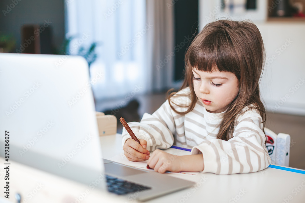 Little girl drawing on the online art lesson Little girl drawing on the online art lesson