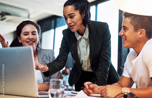 Obraz This right here is our winning idea. Shot of a group of businesspeople working together on a laptop in an office.